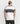 Back view of a model wearing the white Ariiston spray paint graphic t-shirt