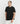 Close-up of a model wearing the black Ariiston acid emboss graphic t-shirt