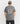Back view of a model in the sharkskin grey 'Rebel Skull' graphic t-shirt