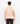 Back view of a model in the Ariiston flat knit stripe polo shirt in sand